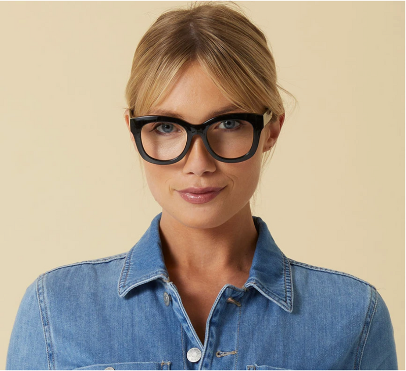 A woman modeling the Center stage focus readers, by Peepers, in black.