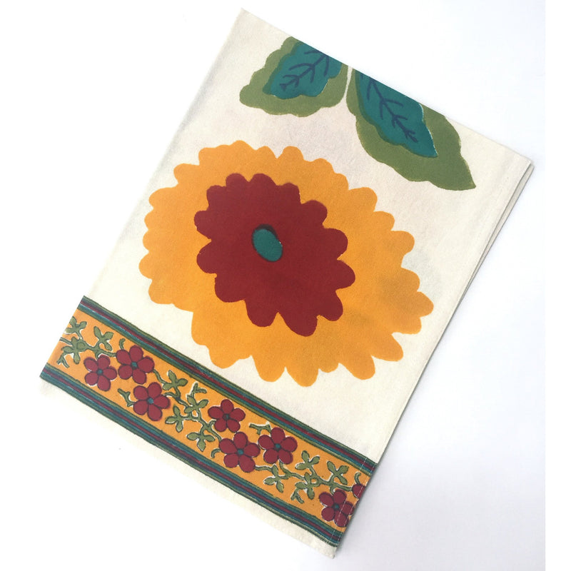 Kitchen towel in floral blockprint of reds, yellows, teals and greens.